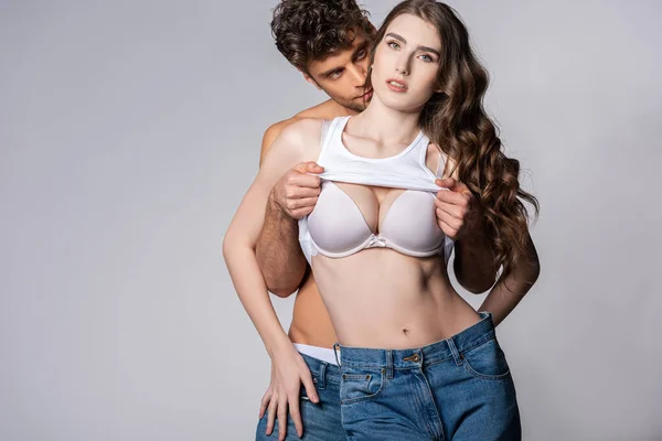 Handsome Man Undressing Girlfriend Bra Isolated Grey — Stock Photo, Image