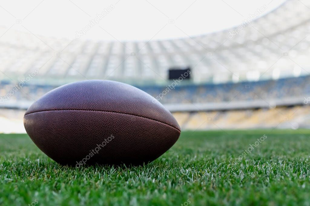 rugby ball on green grass at stadium