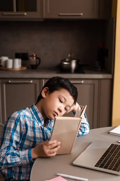 Asian Kid Reading Book Studying Online Laptop Home Self Isolation — Stock Photo, Image