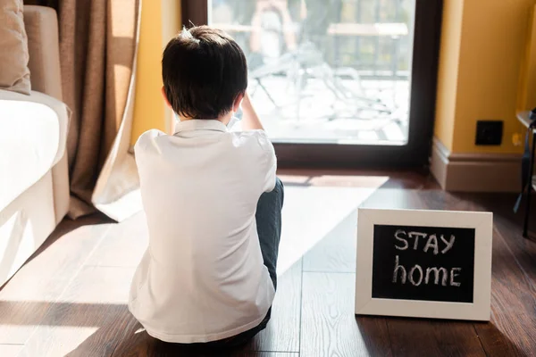 Back View Boy Sitting Floor Stay Home Lettering Board Self — Stock Photo, Image