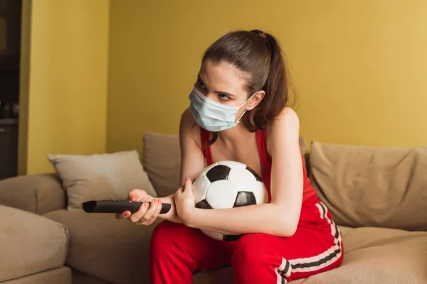 Sportive Girl Medical Mask Holding Remote Controller Football While Watching — Stock Photo, Image