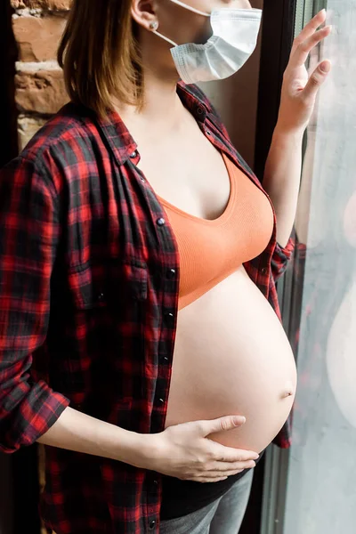 Cropped View Pregnant Woman Medical Mask Touching Belly Window — Stock Photo, Image