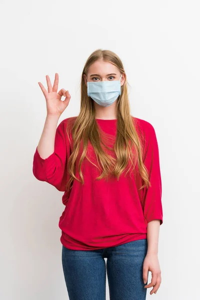 Νεαρή Γυναίκα Ιατρική Μάσκα Δείχνει Σημάδι Απομονώνονται Λευκό — Φωτογραφία Αρχείου