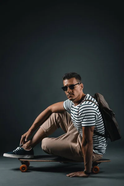 Stylish man with skateboard — Stock Photo