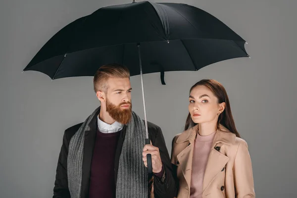 Fashionable couple with umbrella — Stock Photo