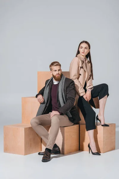Stylish couple on wooden blocks — Stock Photo