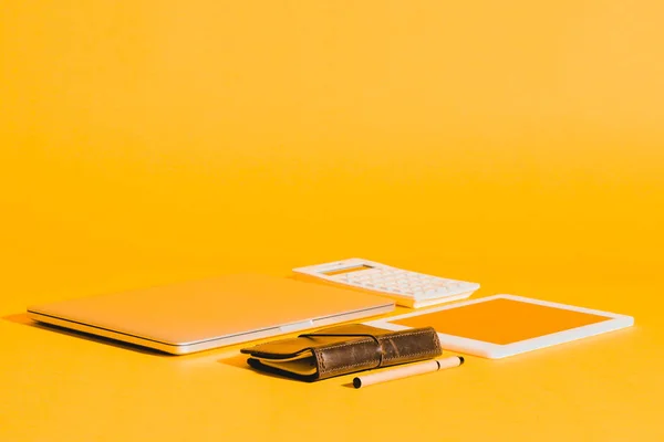 Digital devices on yellow — Stock Photo
