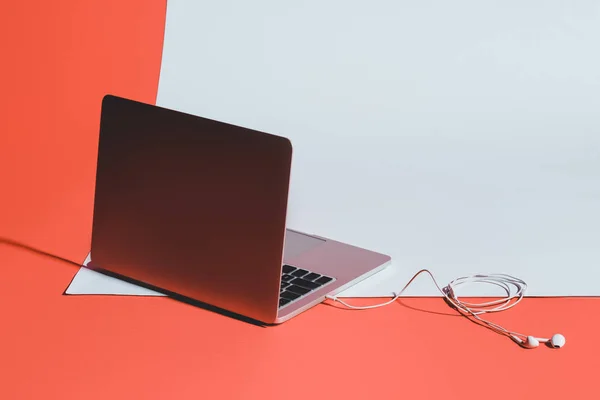 Laptop and earphones — Stock Photo