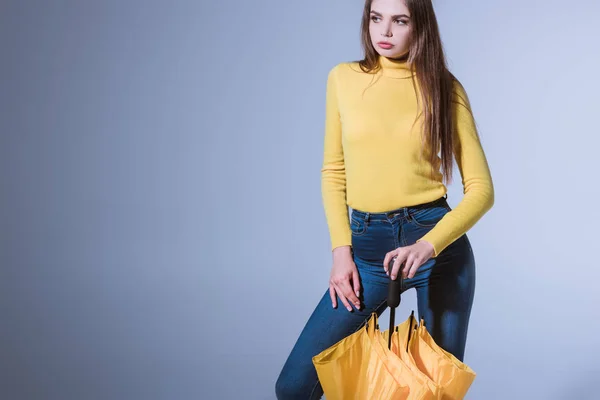 Girl with yellow umbrella — Stock Photo