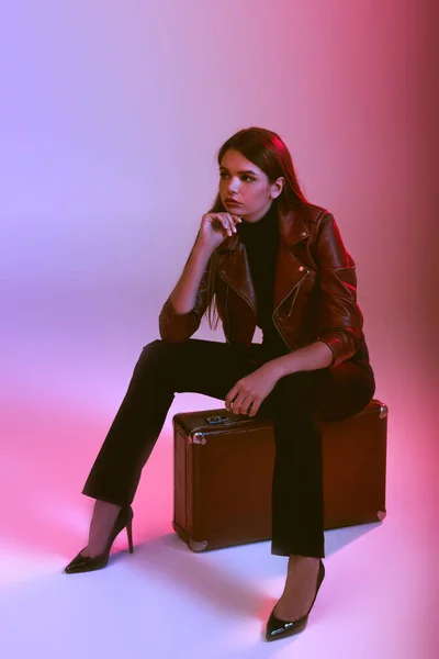 Model sitting on suitcase — Stock Photo