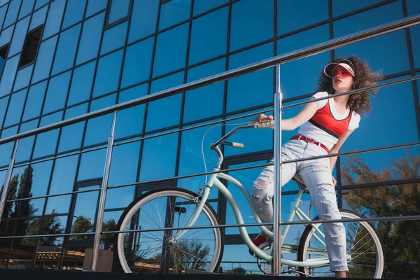 Stylish woman with bicycle — Stock Photo