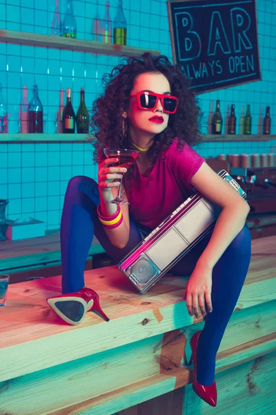 Stylish woman with cocktail and boombox — Stock Photo