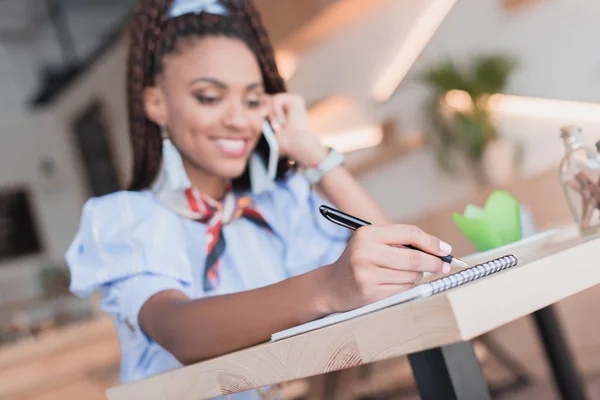 African american woman talking on phone in cafe — Stock Photo