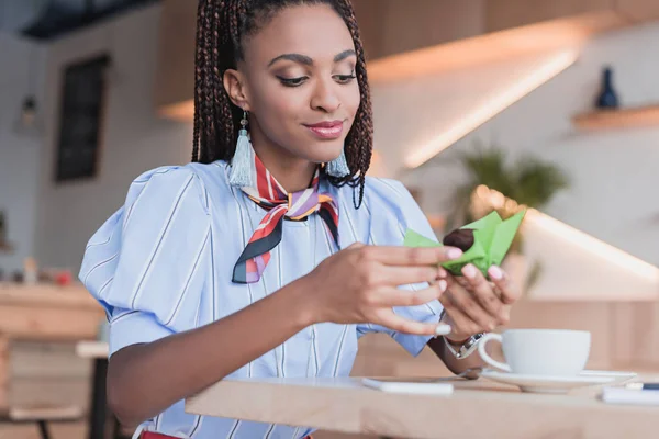 African american woman eating muffin in cafe — Stock Photo