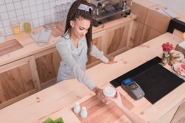 Barista giving customer paper cup — Stock Photo