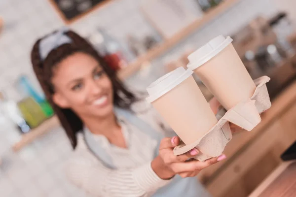 Barista handing out holder with cups — Stock Photo