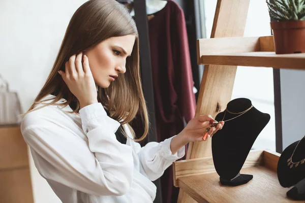 Mujer eligiendo collar - foto de stock