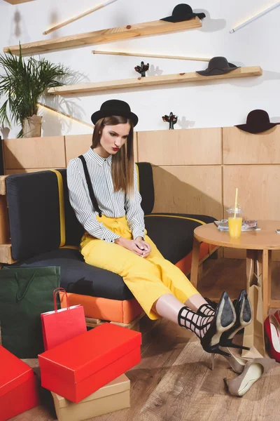 Stylish girl choosing heels — Stock Photo