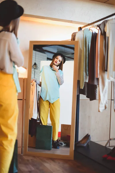 Fashionable girl choosing clothes — Stock Photo