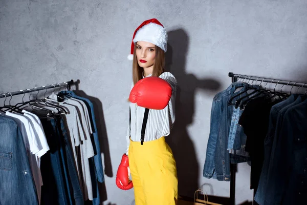 Girl in boxing gloves in boutique — Stock Photo