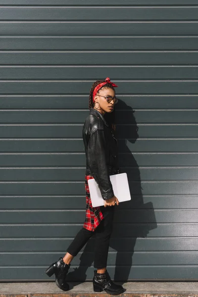 Stylish african american girl with laptop — Stock Photo