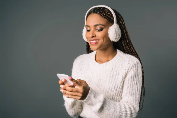 Girl in winter outfit with smartphone — Stock Photo