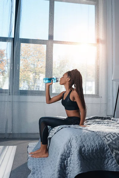 Sportive woman drinking water — Stock Photo
