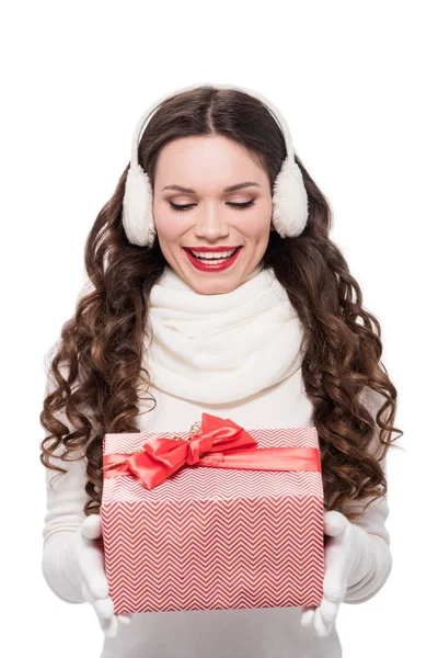 Woman in winter attire holding present — Stock Photo