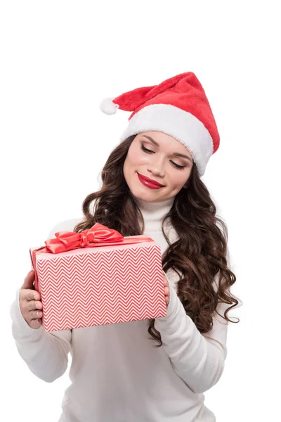 Woman in santa hat holding present — Stock Photo