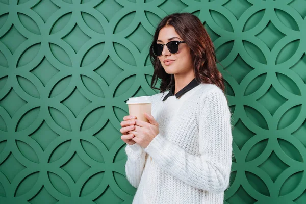 Woman in sunglasses with disposable coffee cup — Stock Photo