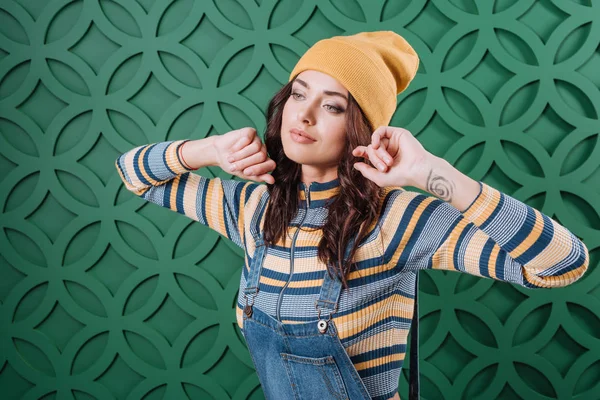 Woman posing in pullover, hat and overalls — Stock Photo