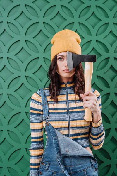 Woman standing with axe in hand — Stock Photo