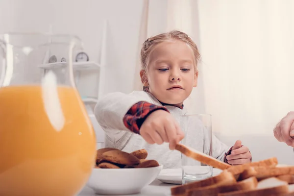 Kid eating toasts — Stock Photo