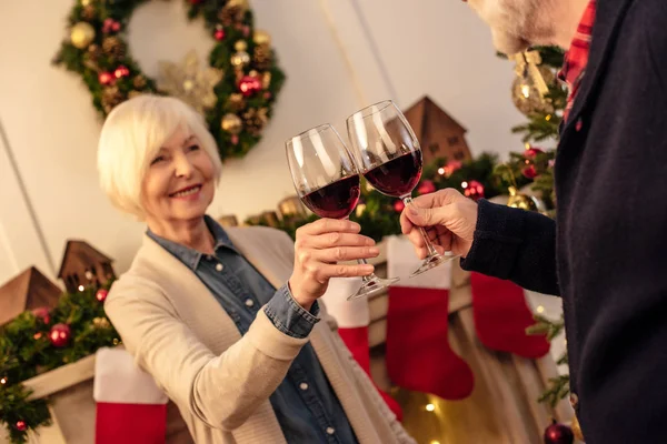 Senior with wine at christmas eve — Stock Photo