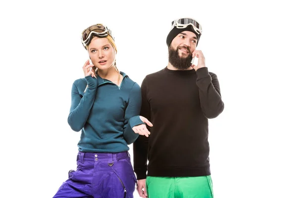 Snowboarders talking on smartphones — Stock Photo