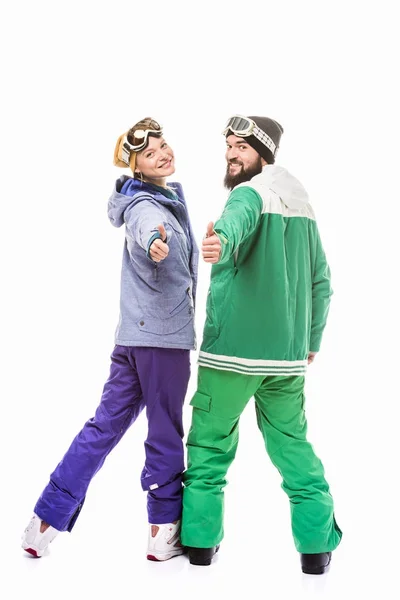 Smiling snowboarders showing thumbs up — Stock Photo