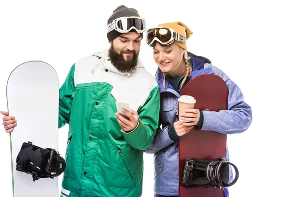 Casal com snowboards usando smartphone — Fotografia de Stock