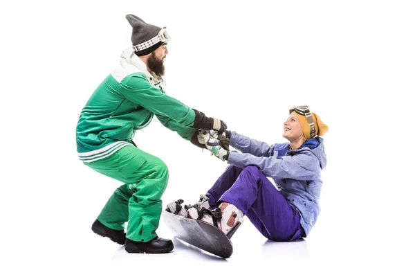 Snowboarder ajudando namorada a se levantar — Fotografia de Stock