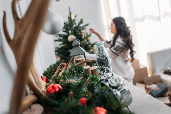 Woman decorating christmas tree — Stock Photo