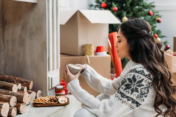 Woman with mug of hot drink on christmas — Stock Photo