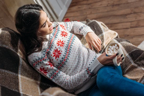 Woman holding mug of cocoa with marshmallow — Stock Photo