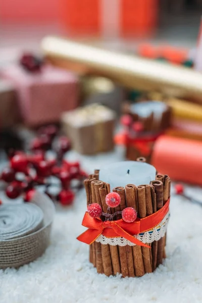 Christmas candle decorated with cinnamon sticks — Stock Photo