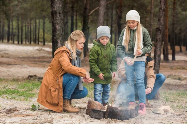 Family making campfire — Stock Photo
