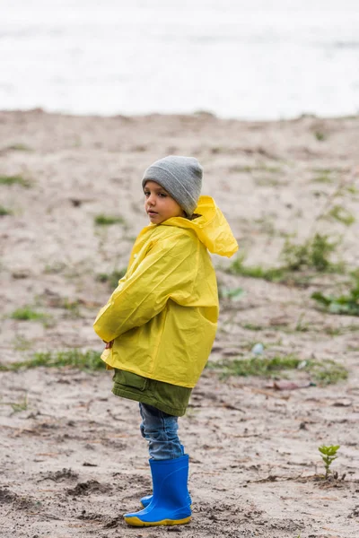 Niño en impermeable amarillo - foto de stock