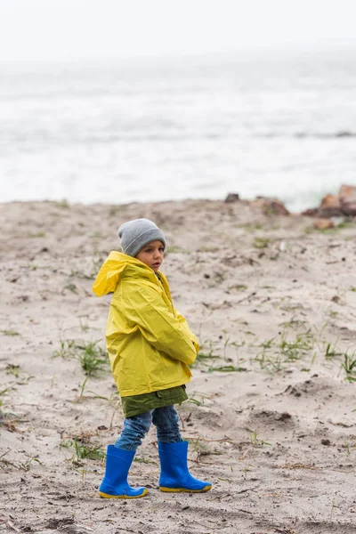 Niño en impermeable amarillo - foto de stock