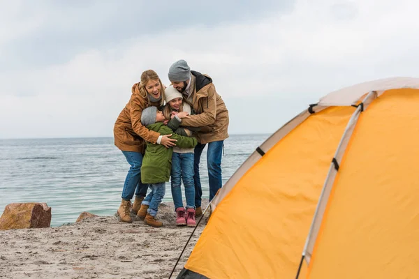 Happy family camping on seashore — Stock Photo