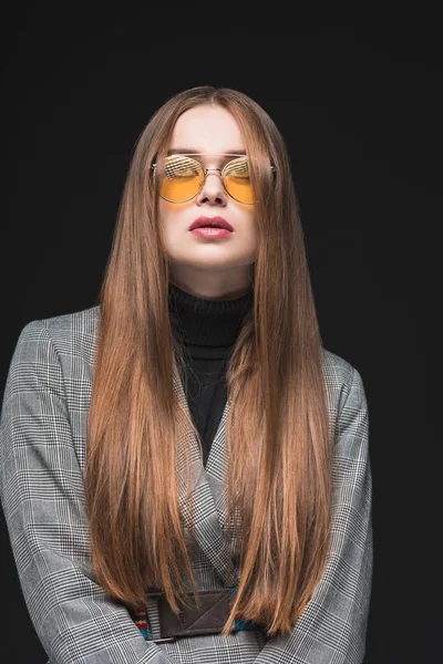 Woman in gray jacket and yellow sunglasses — Stock Photo