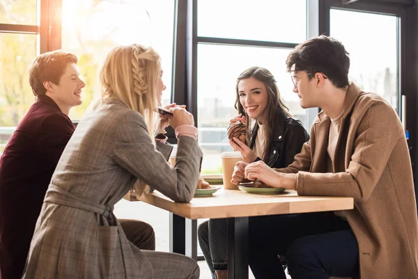 Friends sitting at cafe — Stock Photo