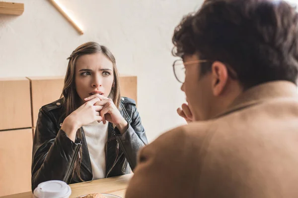 Girl sitting surprised — Stock Photo