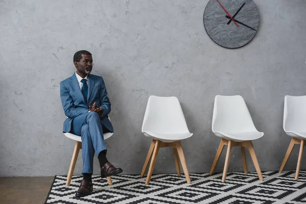 Businessman sitting in waiting room — Stock Photo